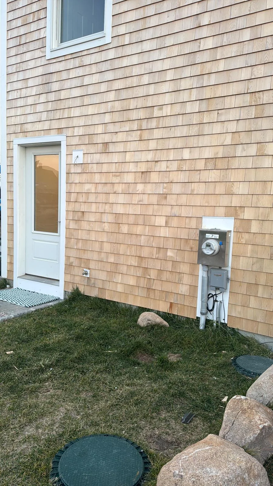 Finished cedar shingles around an exterior doorway