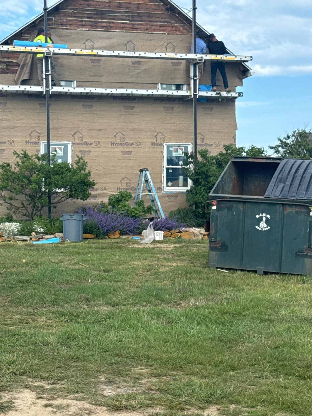 Exterior renovation with house wrap and new windows